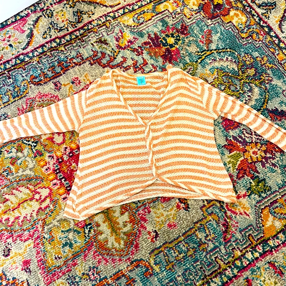 Very cute striped cardigan in orange and beige. Snap buttons. Size medium.